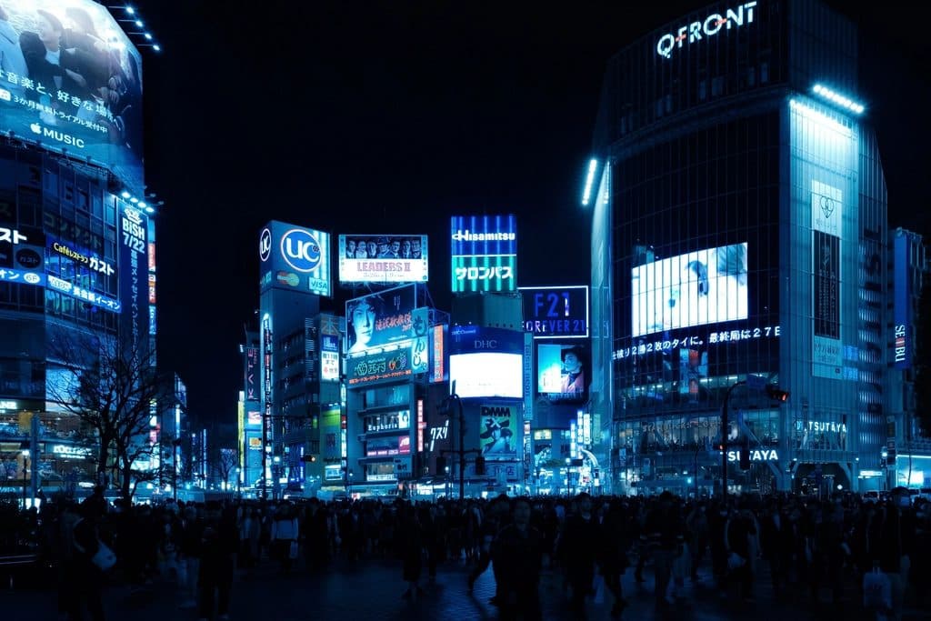 Tokyo street lit by signs at night